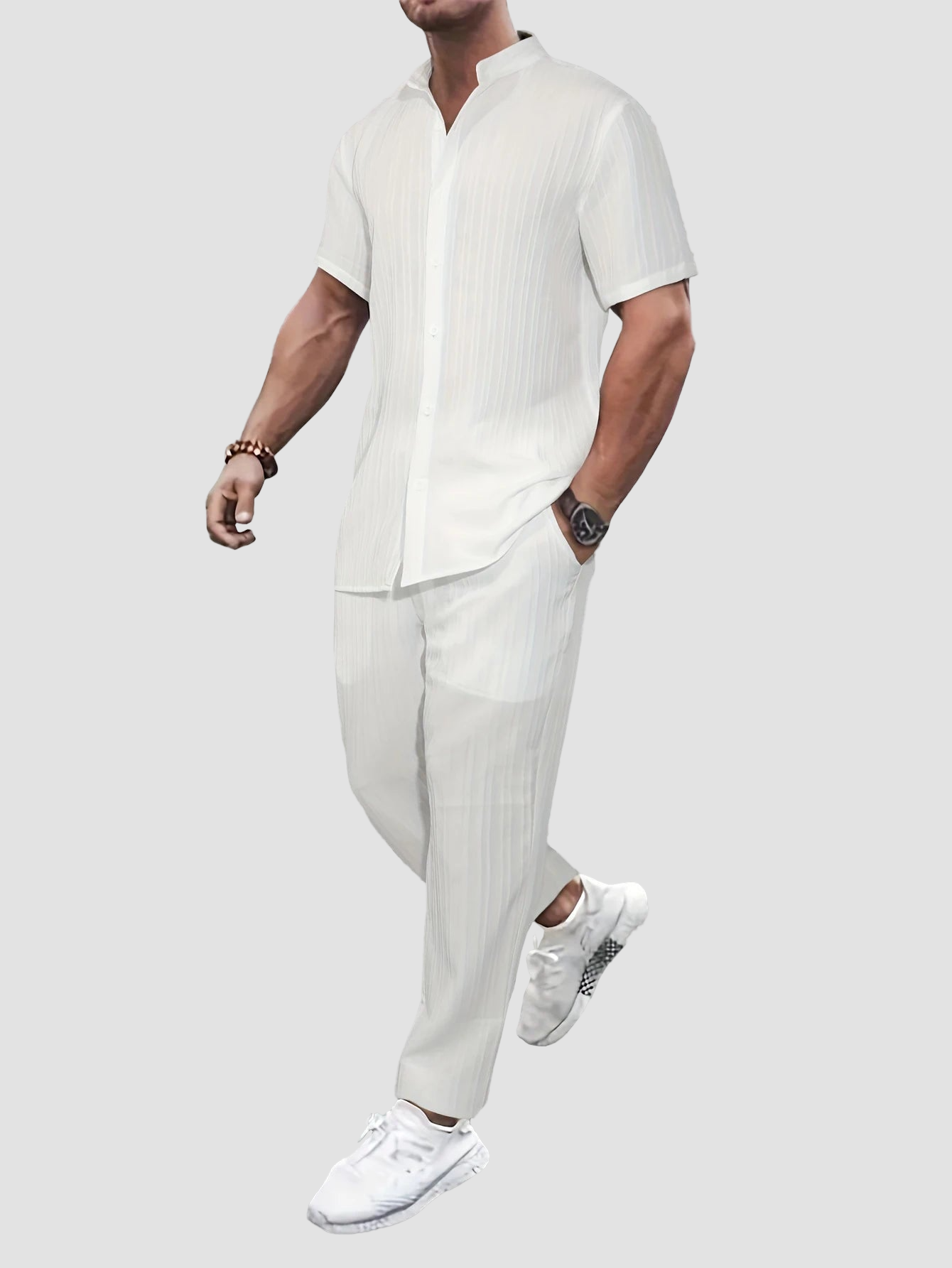 a man in a white shirt and pants jumping in the air