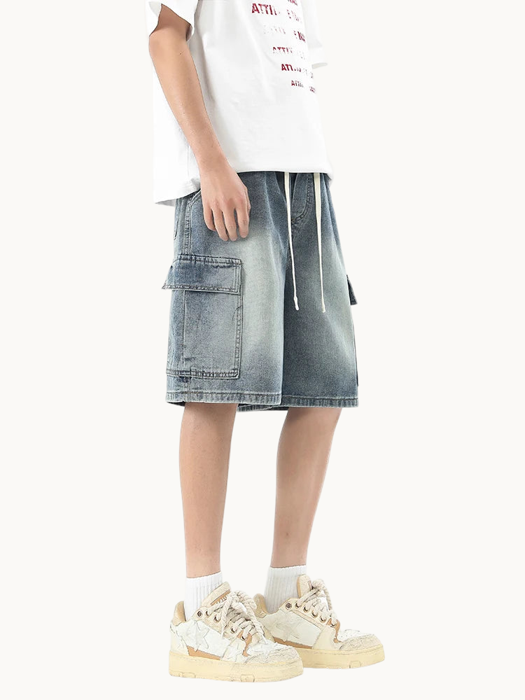 a man in a white t - shirt and denim shorts
