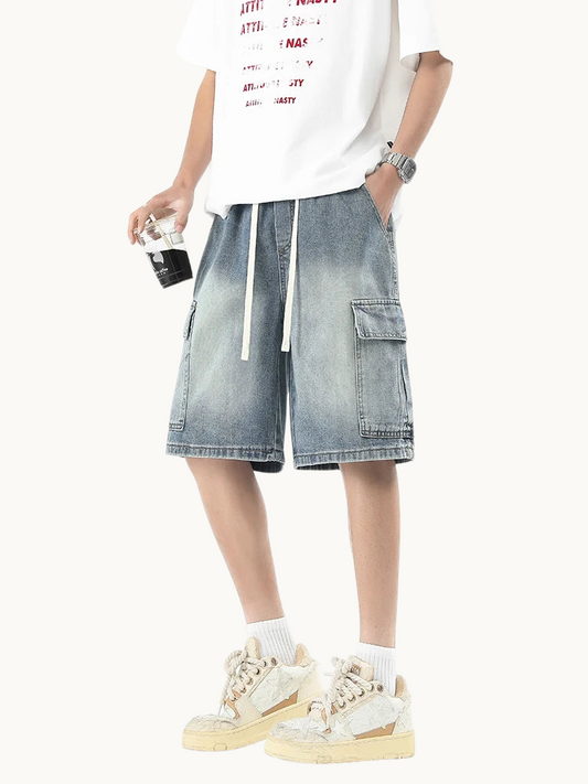a man in a white t - shirt and denim shorts